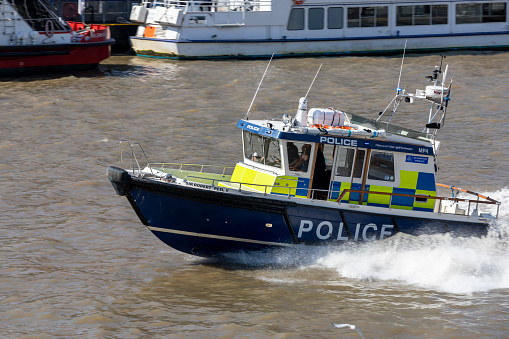 London, England - 7 Sep 2021: Metropolitan Police motorboat at speed on the River Thames