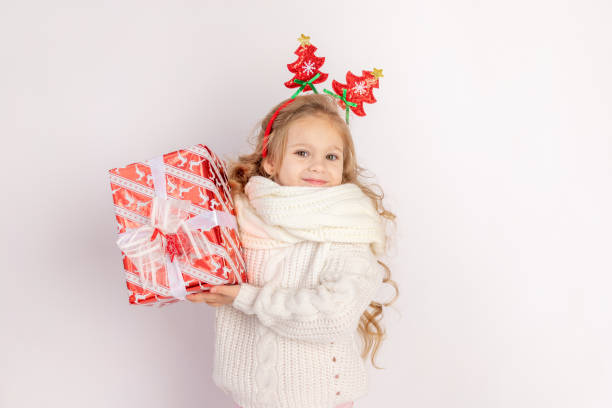 istock baby girl holding red gift on white isolated background, space for text 1339257973