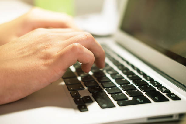 istock Male hands on laptop keyboard close up 1339259917