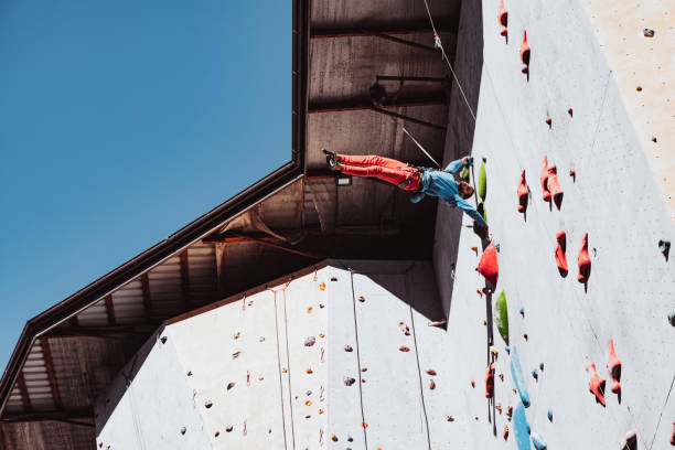 istock Difficult tricks. Young man professional rock climber practicing at training center in sunny day, outdoors. Concept of healthy lifestyle, activity 1339262608