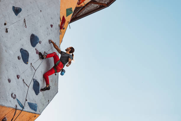 istock Young man professional rock climber practicing at training center in sunny day, outdoors. Concept of healthy lifestyle, tourism, nature, motion. 1339262634