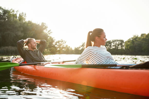 istock Relaxed young caucasian couple resting while boating together on river on weekend 1339264234