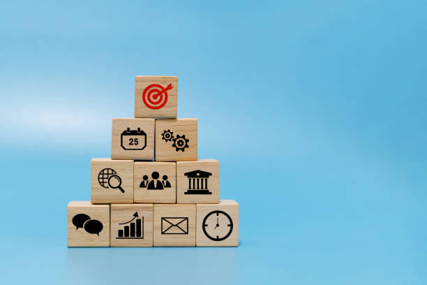 istock Goal. business finance icon on wooden cube block pyramid stack on blue background with copy space, online marketing, banking, investment, business strategy, internet technology and financial concept 1339266542