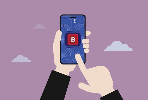 Hand holding a mobile phone for use cryptocurrency