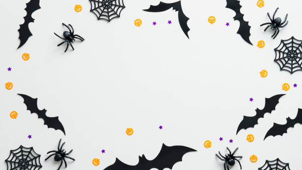 istock Happy Halloween holiday concept. Halloween decorations on white background. Flat lay, top view spiders, web, bats, confetti. 1339267044