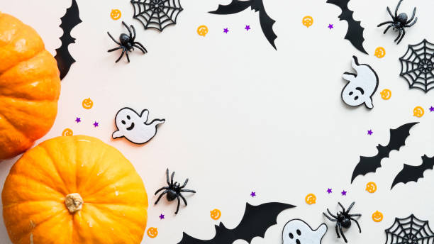 istock Happy Halloween frame made of pumpkins, ghosts, bats, spiders, web on white background. Flat lay, top view, copy space. Halloween banner mockup. 1339267052