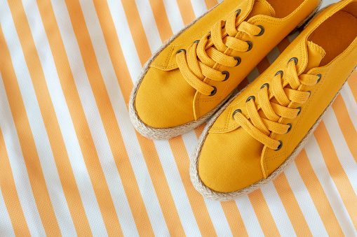 Yellow sneakers on a striped background