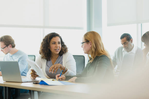 istock Diverse adult students work together and independently during class 1339268565