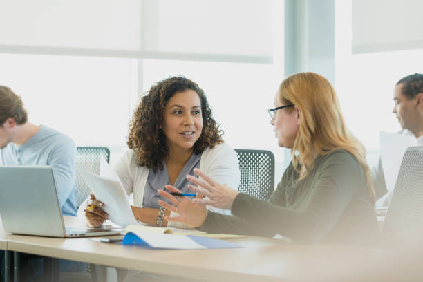 istock Mid adult women collaborate on presentation 1339268567