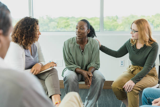 istock Woman comforts friend as she talks to therapist 1339268585