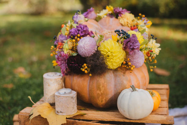 istock Large pumpkin with purple and yellow flowers 1339268749