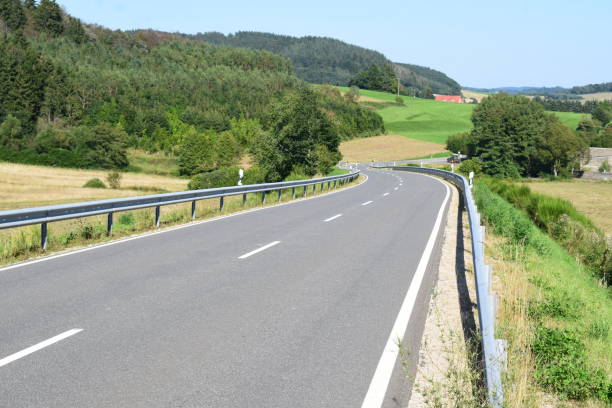 istock wide main road through an Eifel valley with a weird curve 1339270491