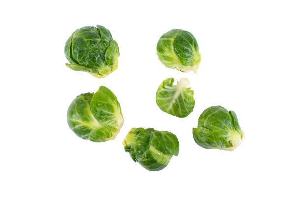 Organic Brussels Sprouts Raw organic brussels sprouts isolated on white background. brussels sprout stock pictures, royalty-free photos & images