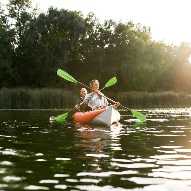 istock Adventurous young caucasian couple kayaking on river with trees in the background 1339271776