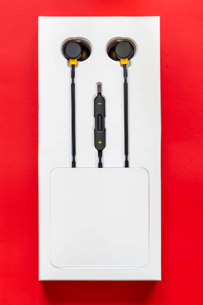 istock Black wired headphones on red background 1339271802