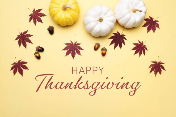 istock Happy Thanksgiving Day with pumpkin and nut on yellow background 1339271966