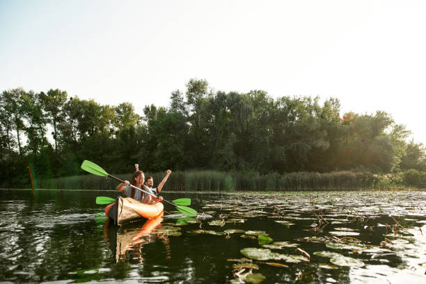 istock Joyful young mixed couple spending time together, kayaking on river surrounded by wild nature 1339272104
