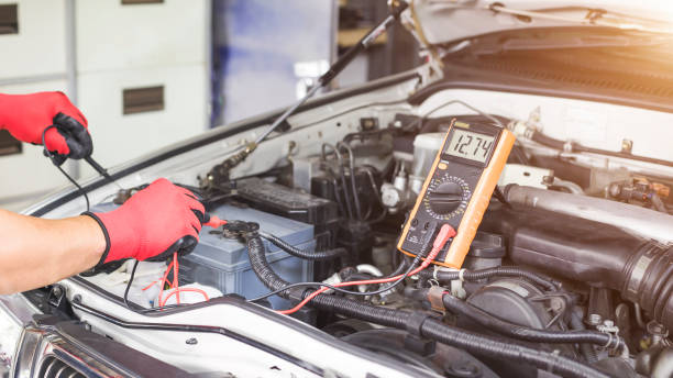 istock A technician is checking the car battery for availability. 1339272188