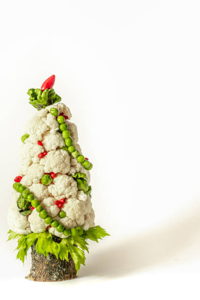 istock Christmas tree vegetable from cabbage on a white background. Vegetarian Christmas food concept and copy space 1339274945