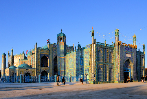 Mazar-i-Sharif, Balkh province, Afghanistan: Shrine of Ali (Hazrat Ali Mazar) south view with gate on Rawza square - also known as the Blue Mosque or Rawza, considered by the Afghans) as the burial place of Ali ibn Abi Talib, the son-in-law of Muhammad and one of the most important personalities of Islam. Decoration with Persian style tiles (Qashani).