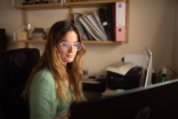 istock Young woman working with computers at home 1339279408