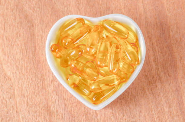istock Heart-shape plate with fish oil capsules 1339279885