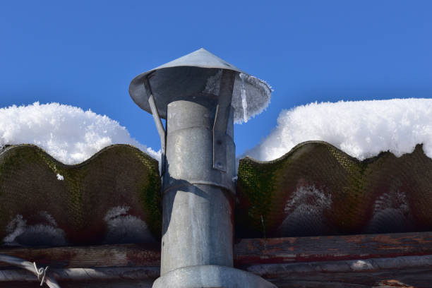 istock Chimney on the roof covered with snow. 1339280101