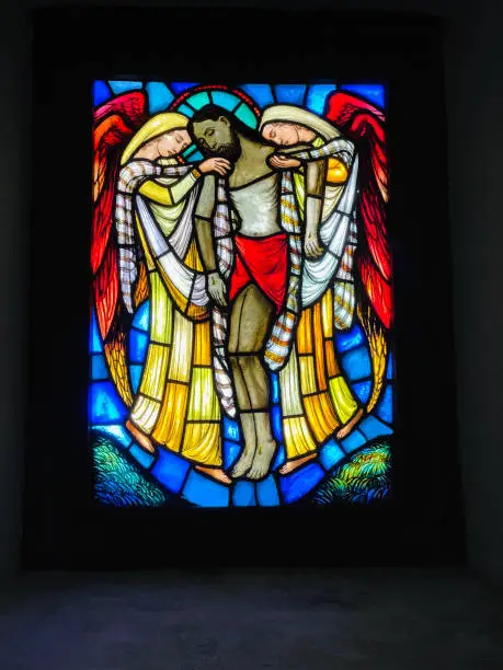 Photo of Church window showing Jesus and two women holding him, stained glass,