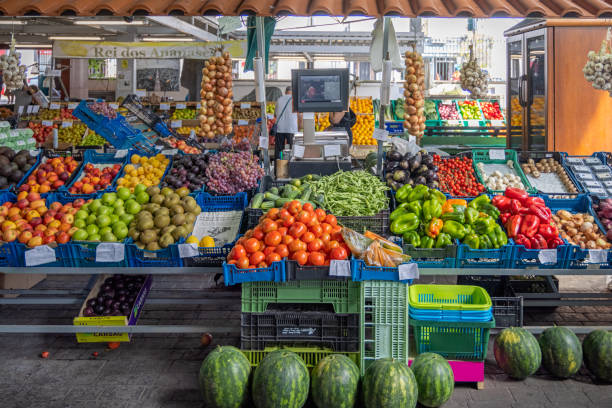 Greengrocers market stall at the mercado which is a marketplace under roof in the center of the city with public access. In several market stalls fresh and locally produced food is sold – mostly fruit and vegetables but also fish and meat. The picture is taken in Ponta Delgada at the Azorean Island San Miguel in the middle of the North Atlantic Ocean.