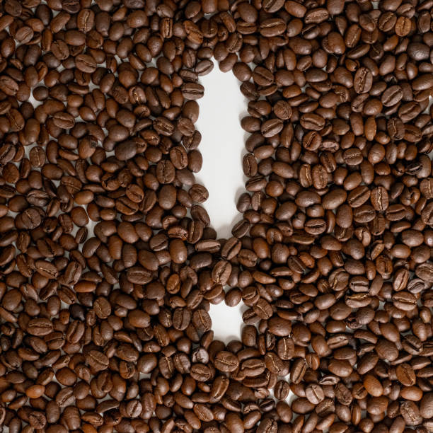 Roasted grains of black coffee forming an exclamation mark. stock photo