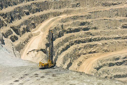 Industrial terraces in a mining quarry. Aerial view of open pit mining. Excavation of the Dolomite Mine. Extractive industry.