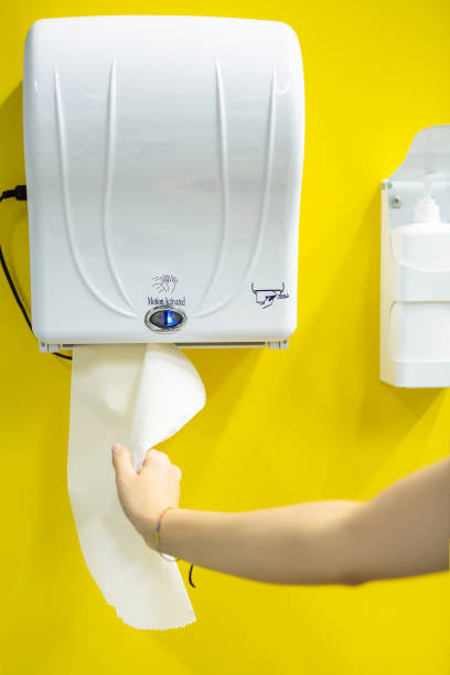 After washing his hands, the man took out toilet paper from under the mirror and close-up photos