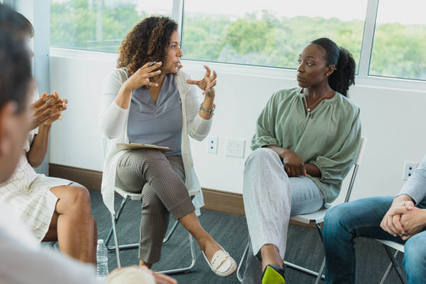 istock Therapist gestures while talking to angry member of group 1339287212
