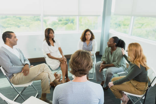 istock Business men and women discuss workplace issues in meeting 1339287217