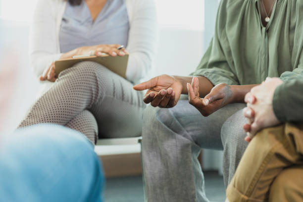 Focus on hands of woman sharing during group therapy A photo with the focus on the hands of the unrecognizable mid adult woman sharing her story during group therapy. Philosophical Counseling stock pictures, royalty-free photos & image