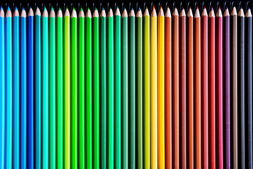 A closeup shot of colored pencils on the grey background