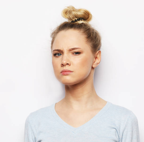 istock Thoughtful young blond woman against white background 1339291337