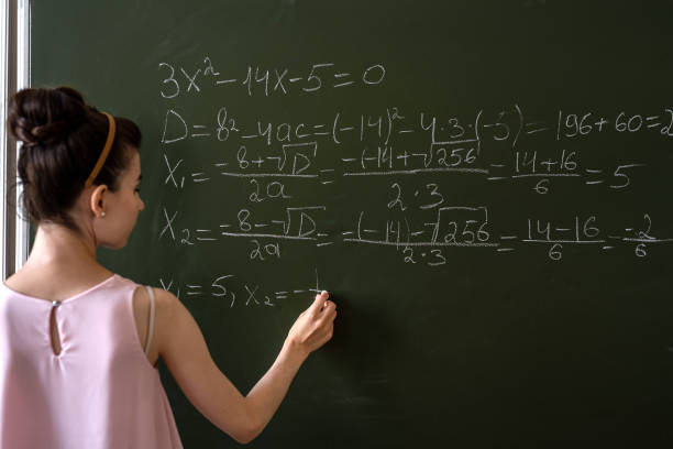 istock schoolgirl writing high school math's formula  with chalk on blackboard 1339291543
