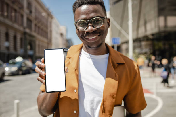 istock Young man holding isolated smartphone screen 1339292385