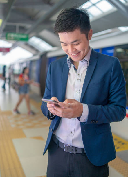 istock Smart Casual Chinese Businessman Texting Message 1339292685