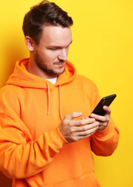 istock young man holding mobile phone and making photo 1339292694