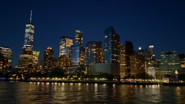 New York City at night Manhattan and Empire State from boat on Hudson River, USA