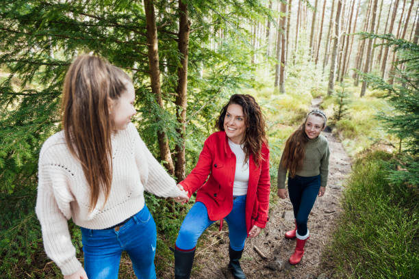 istock Mother and Daughter Walking through the Woods 1339293078