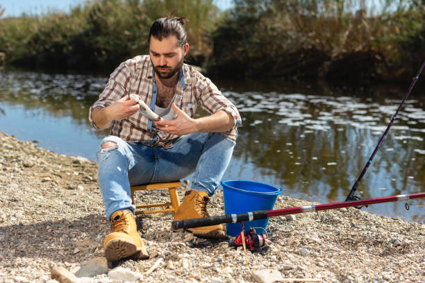 istock Lucky fisherman caught a trout fish 1339294375