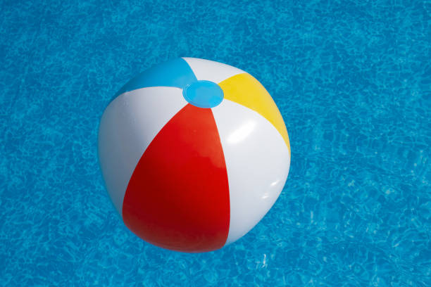 istock Beachball floating in swimming pool water 1339294511