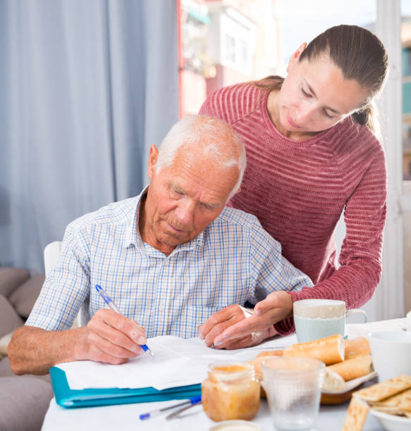 istock Upset mature man sitting with documents, talking with daughter 1339295553