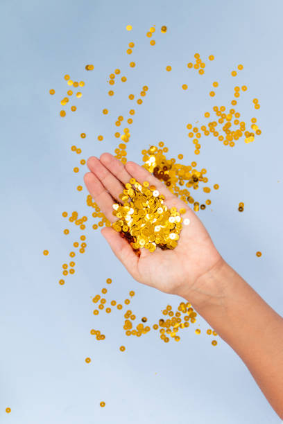 istock Golden confetti on blue background 1339296370