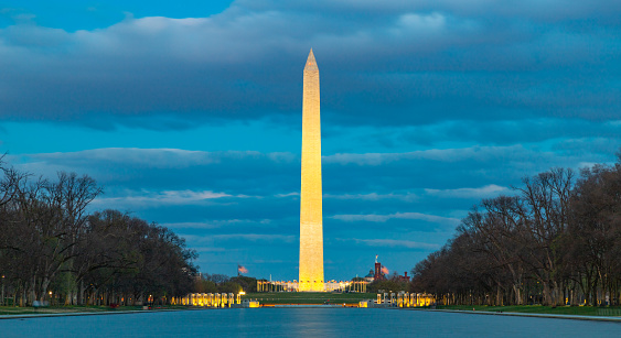 A picture of the Washington Monument at early evening as seen across the Lincoln Memorial Reflecting Pool.