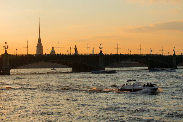 Saint Petersburg, Russia - August 28, 2021: View of the Trinity bridge, Peter and Paul Fortress and Petrograd Side at sunset. Evening cityscape