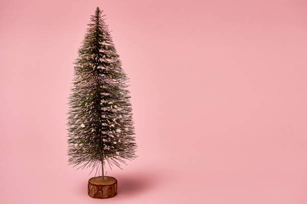 istock Christmas tree on pink background, copy space. Minimal, New year concept 1339298639